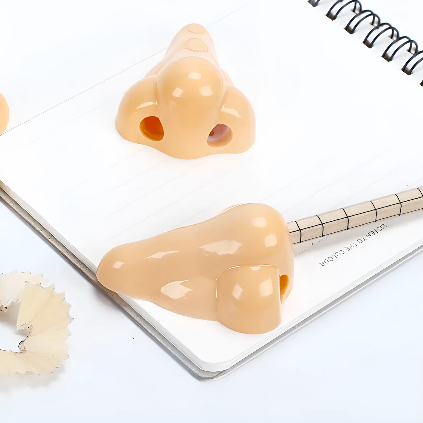 Flesh colour geometry-shaped plastic pencil sharpener with big nostril.