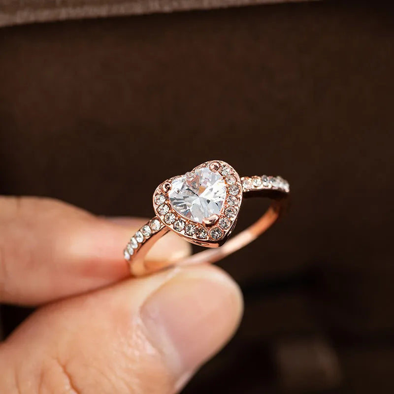 Women's heart-shaped crystal wedding ring in rose gold or silvery on white copper.