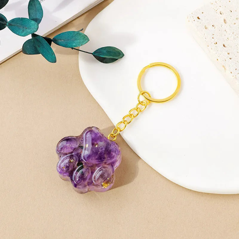 Natural crystal cat's paw keychain pendant in various gemstone colours including pink, red, blue, and green