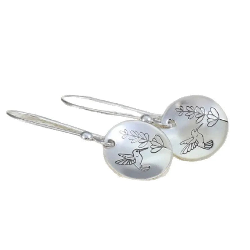Silver-toned round earrings with bird and leaf elements, glossy finish, approximately 2-3cm diameter