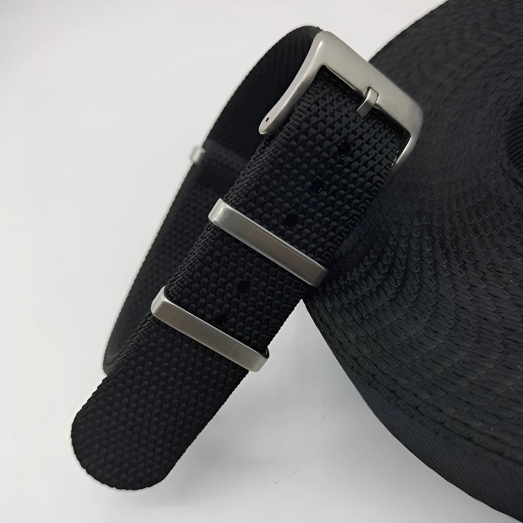 Nylon quick-release watch strap in army green, showing the integrated spring bar mechanism.