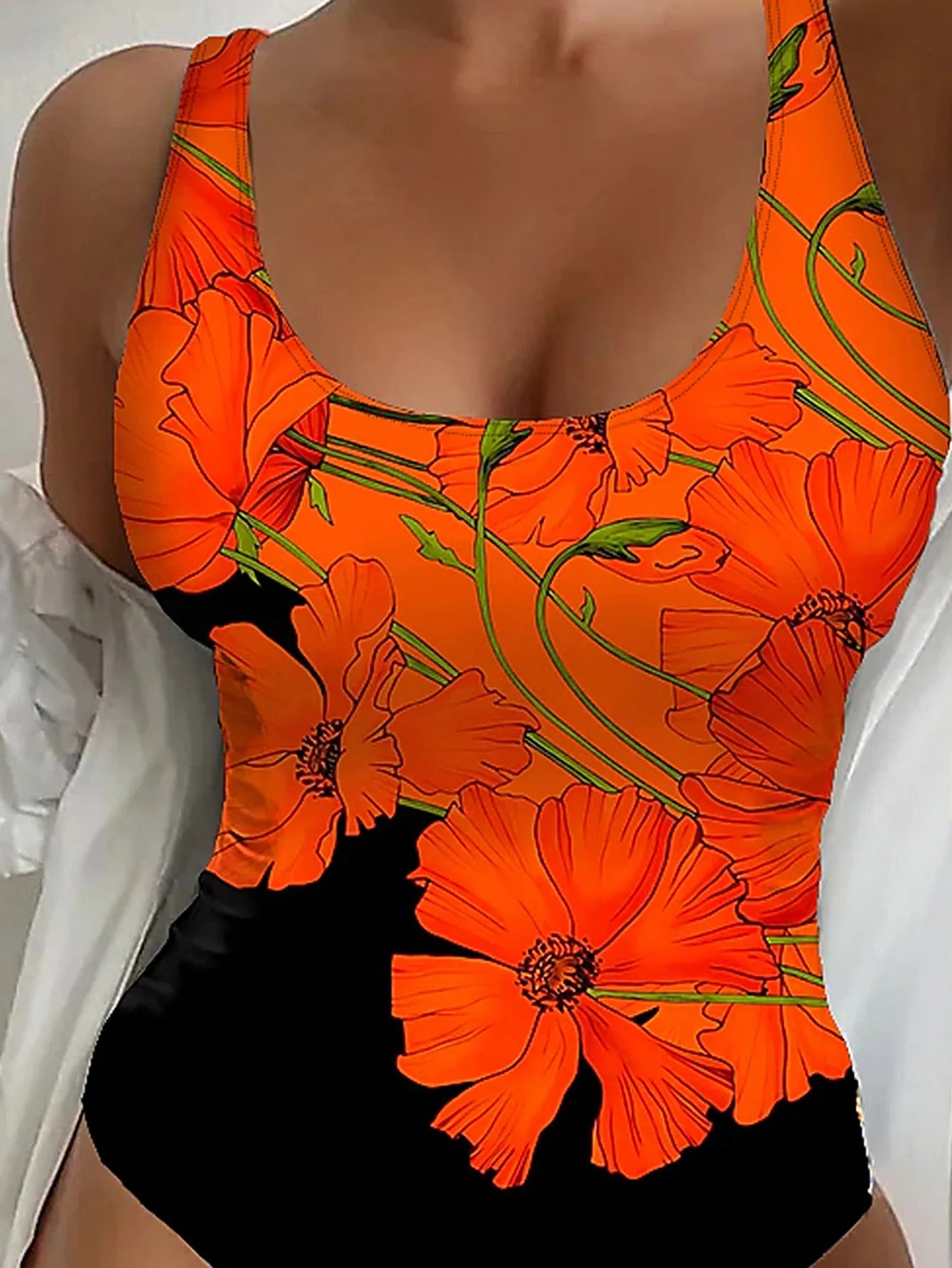 Orange floral print backless one-piece swimsuit laid flat, showing slim fit and polyester material.