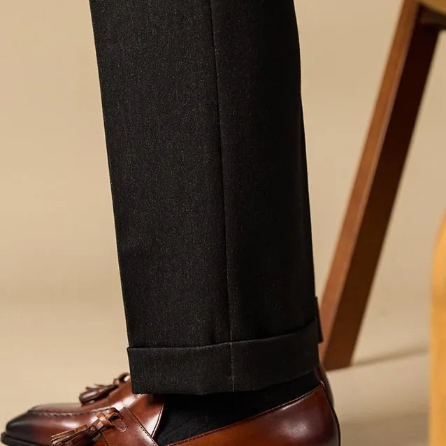Men's black and brown tassel loafers with polished leather uppers and rubber soles