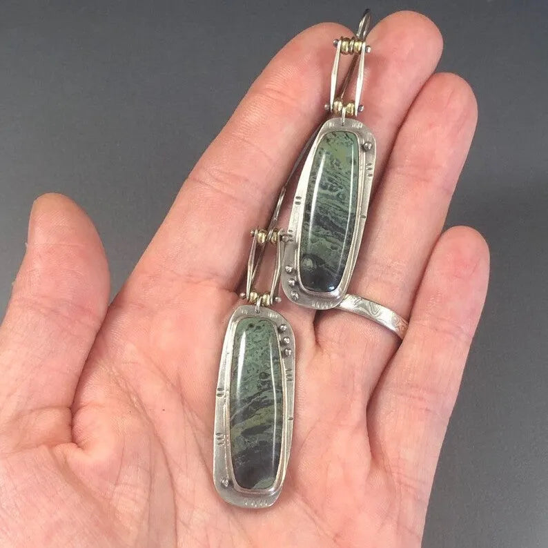 Two-tone geometric marble pattern drop earrings in alloy metal showing contrasting colours