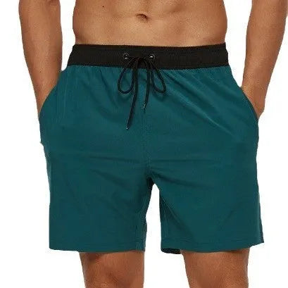 Men's blue drawstring shorts with a zippered pocket and stitching waist detail