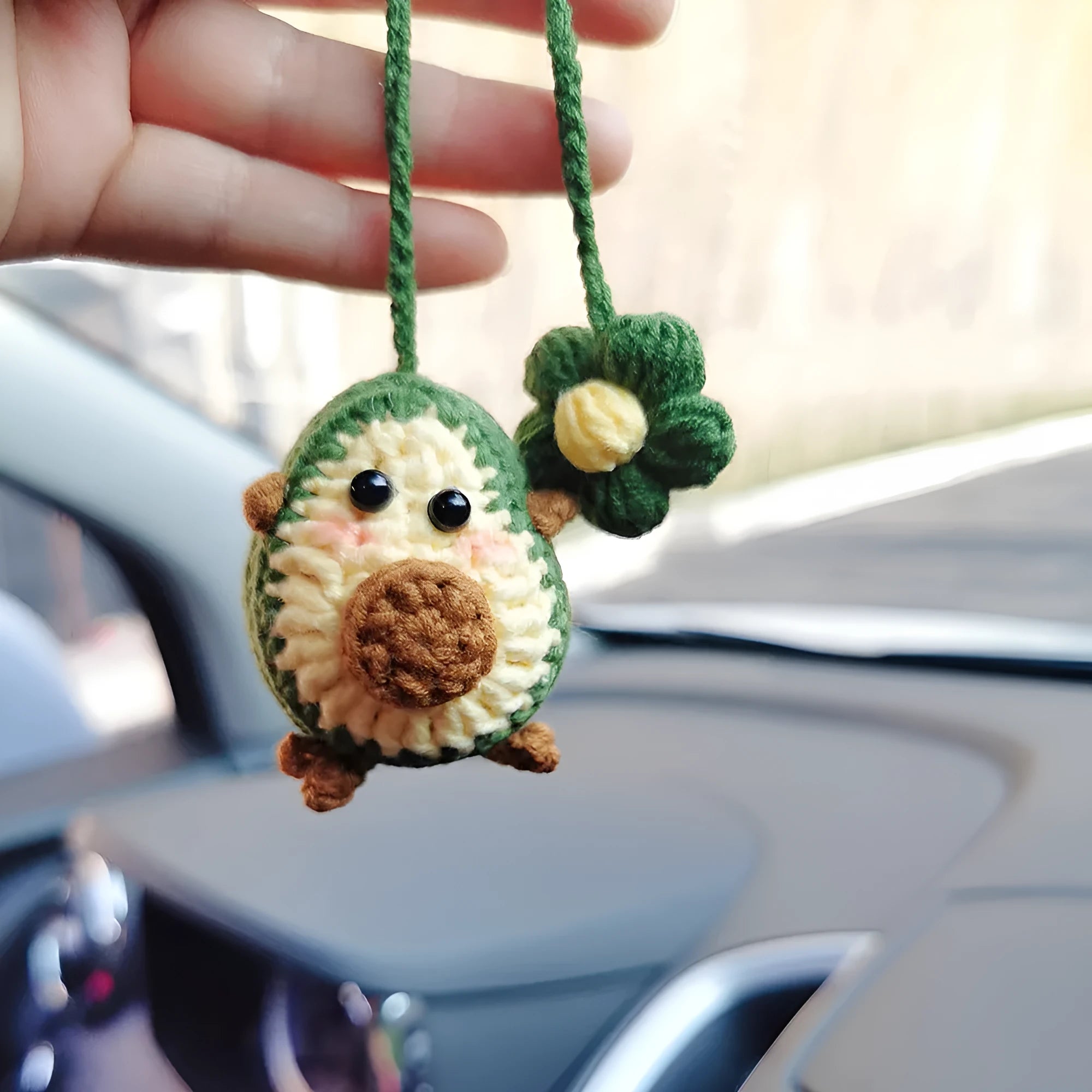 Handmade crocheted wool car pendant with rainbow colours hanging from car mirror