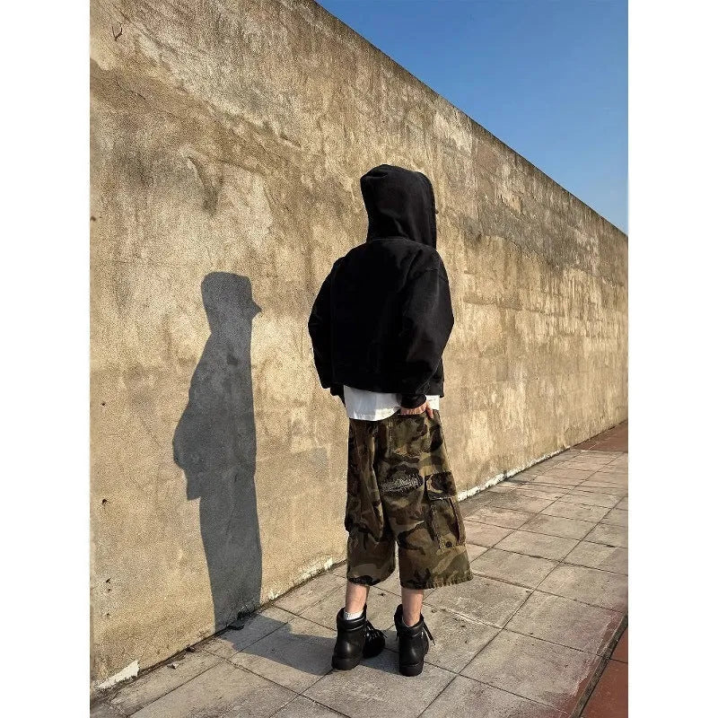 Men's camouflage cropped jeans with retro patches and ripped detailing on loose straight-leg trousers