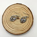Silver colour leaf-shaped women's earrings with embedded colourful moonstones