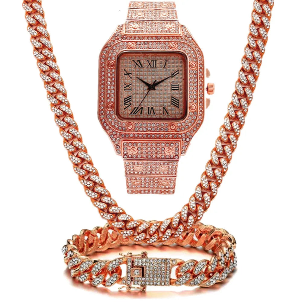 Gold Roman numeral square dial watch with diamond studs and mesh band, part of a three-piece jewellery set.