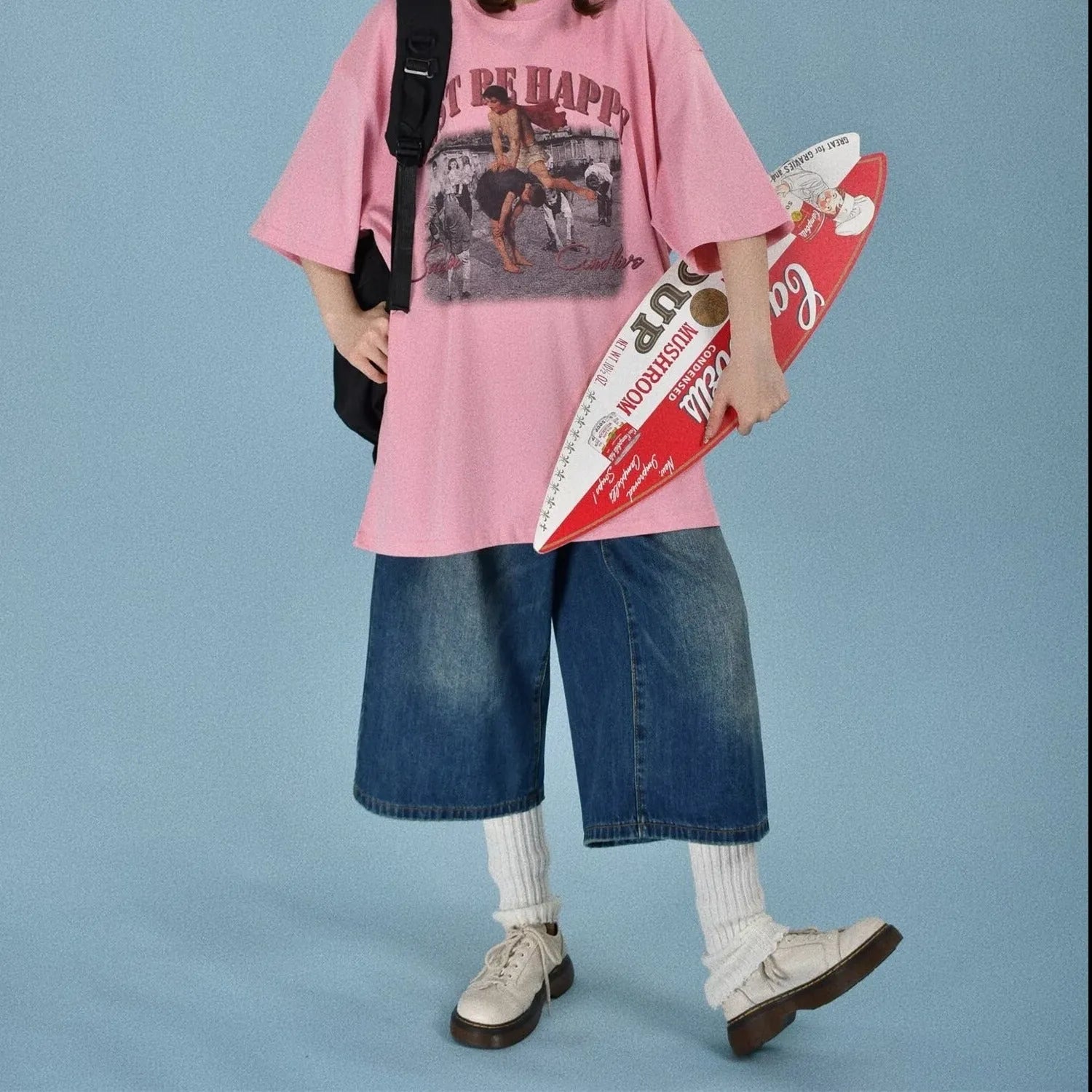 Man wearing blue loose straight-leg denim shorts for summer.