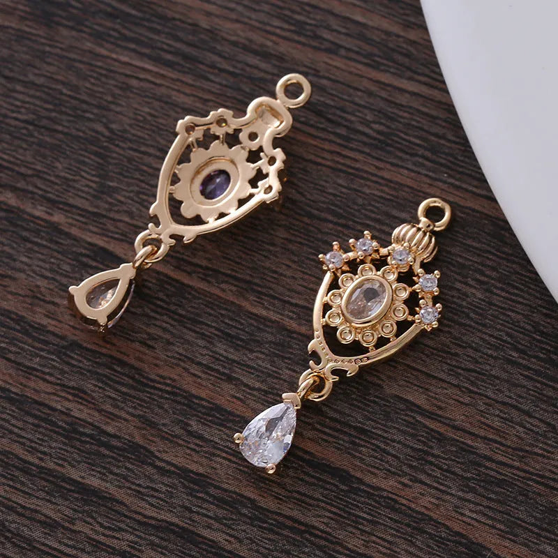 Hollow water drop shaped pendant with micro inlaid zircon on a crown outline in five colour options.