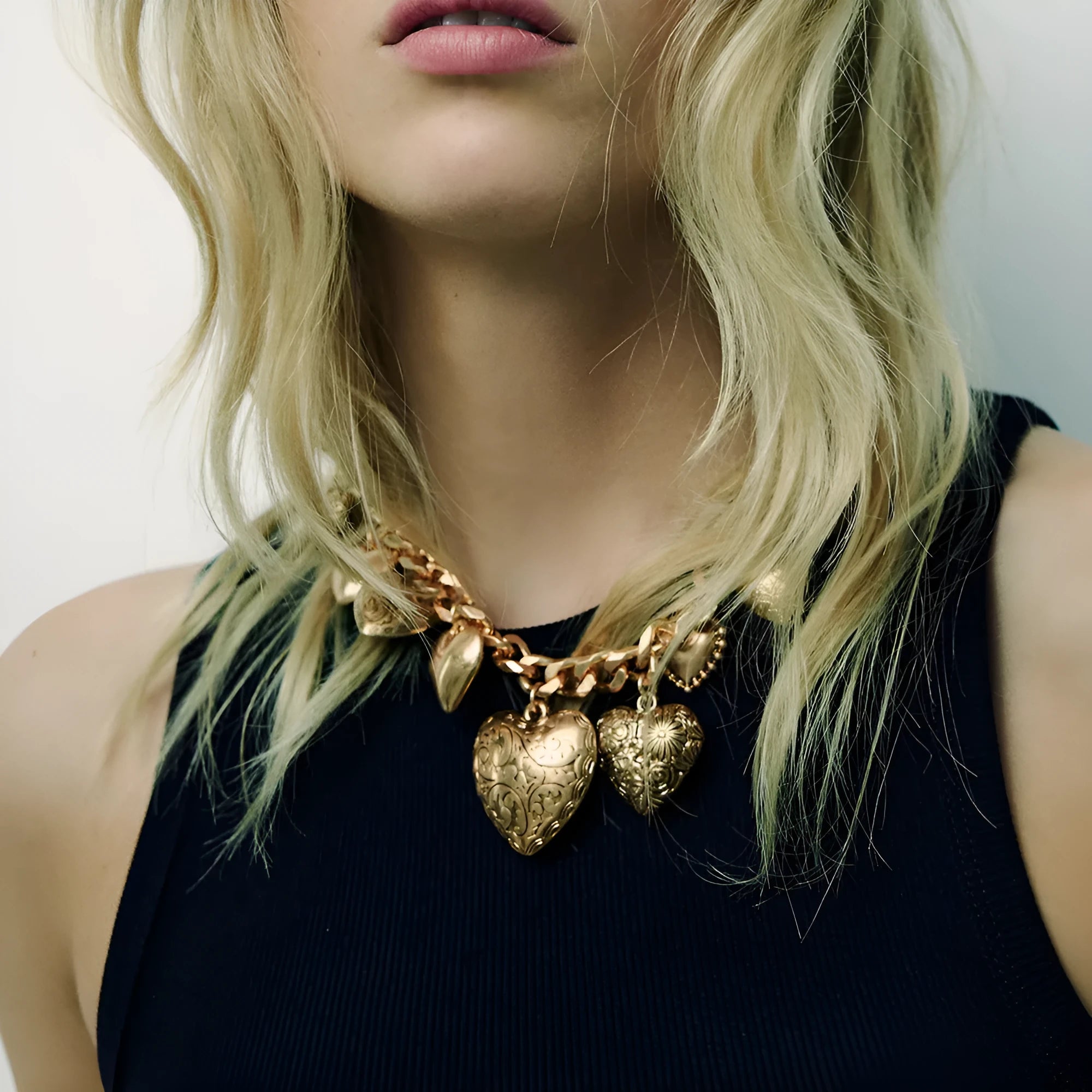 Exaggerated carved heart pendant necklace in gold or white K on an adjustable metal chain.