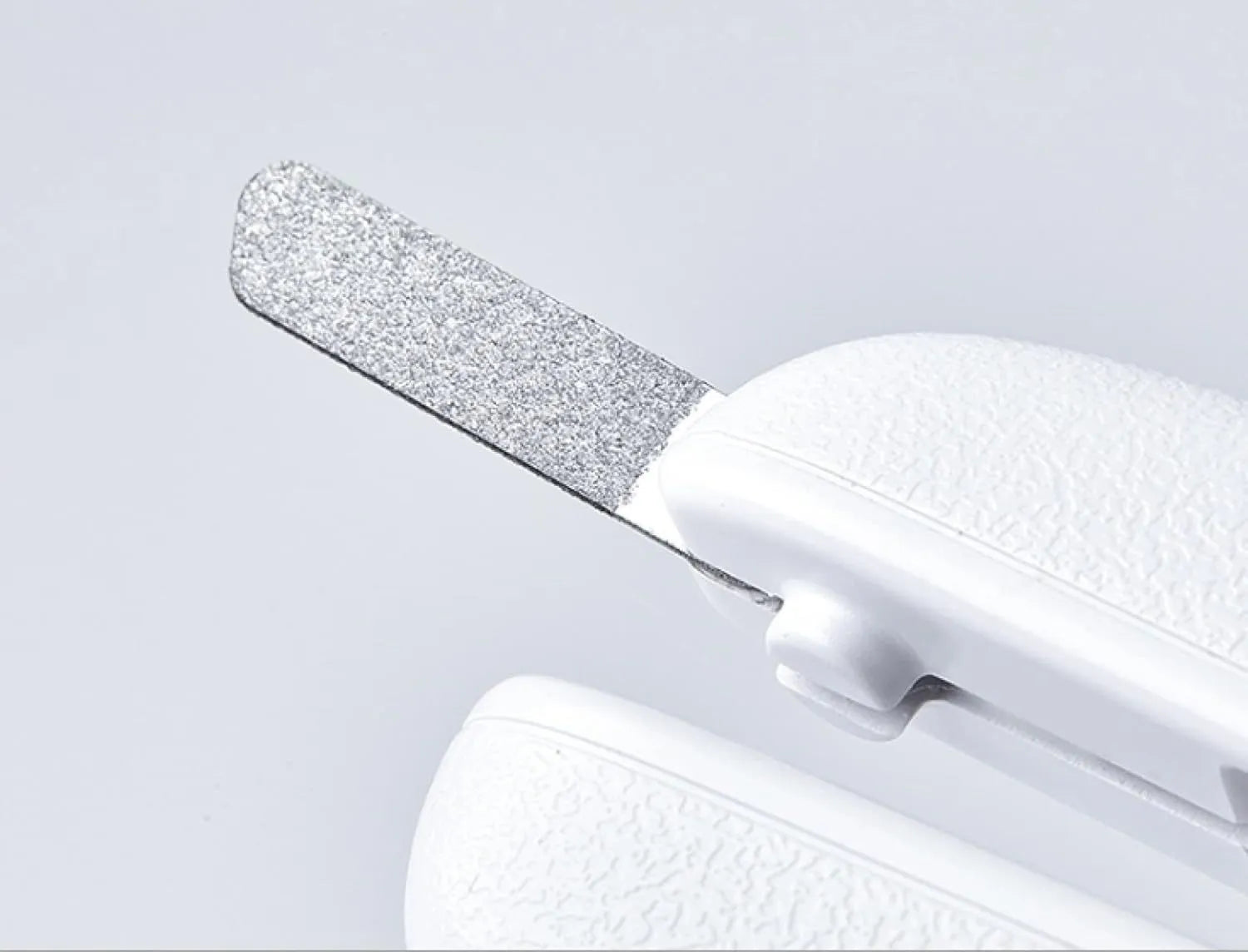 White pet nail clippers with LED light, transparent anti-splash guard and triangular blade for dogs and cats