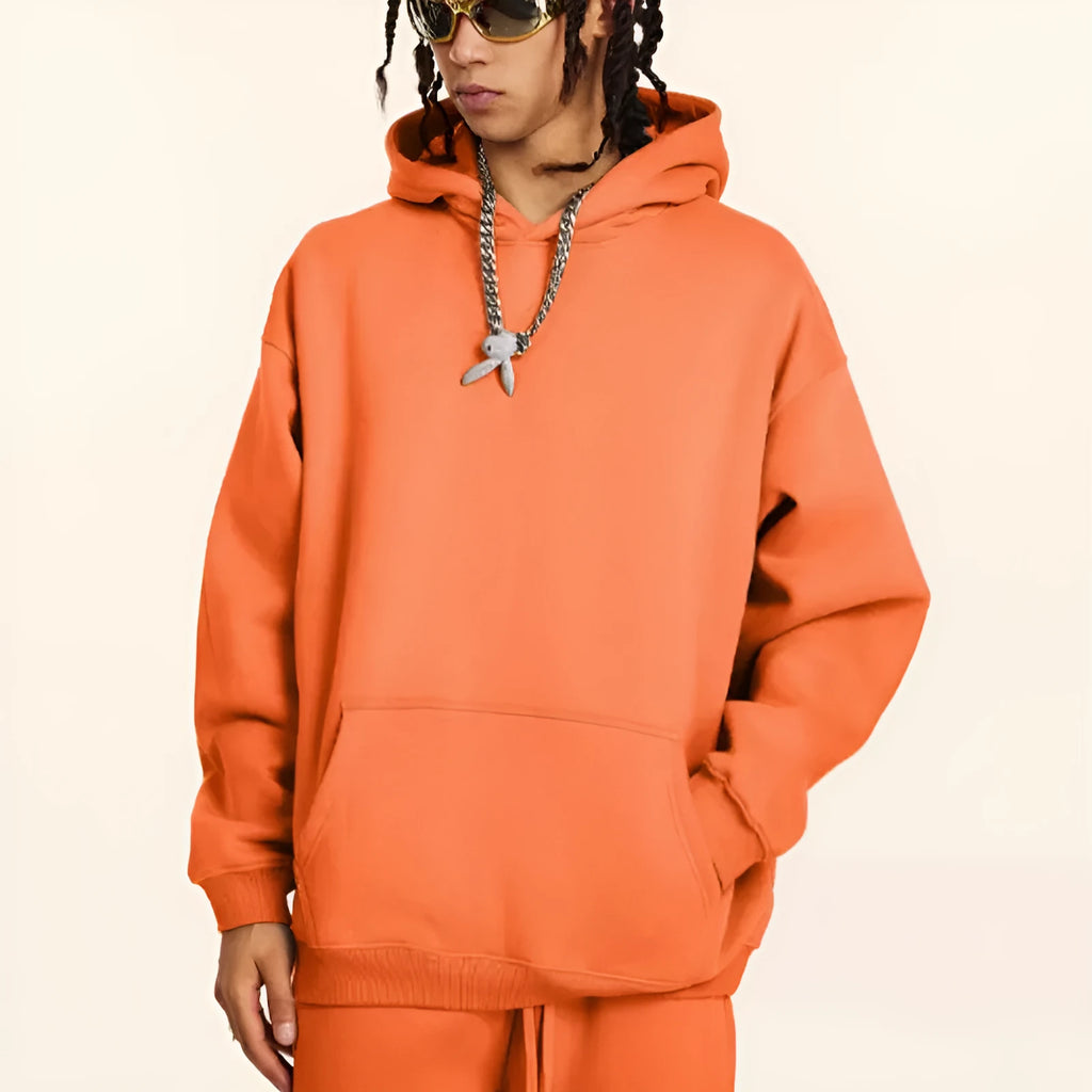 A loose-fit men's hooded sweater in 450g terry cotton with drop shoulders, shown in a solid colour.