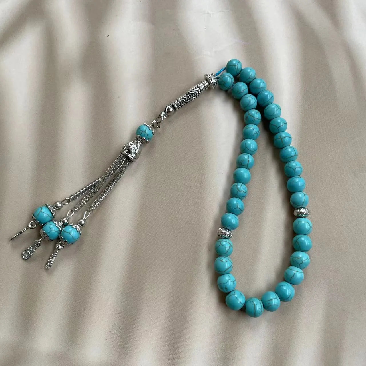Sky blue natural stone bead Muslim prayer bracelet with 8mm spherical beads on a cord.