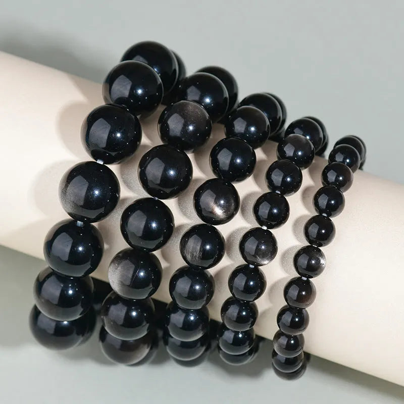 Hand-woven obsidian bracelet with round crystal beads in multiple colour options