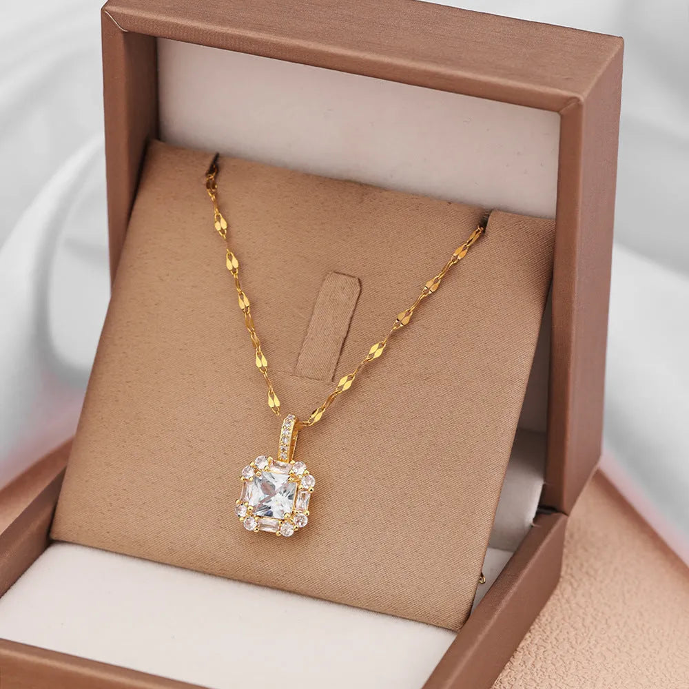 Gold tone geometric quadrilateral pendant necklace with inlaid zircon stones on a water wave chain.