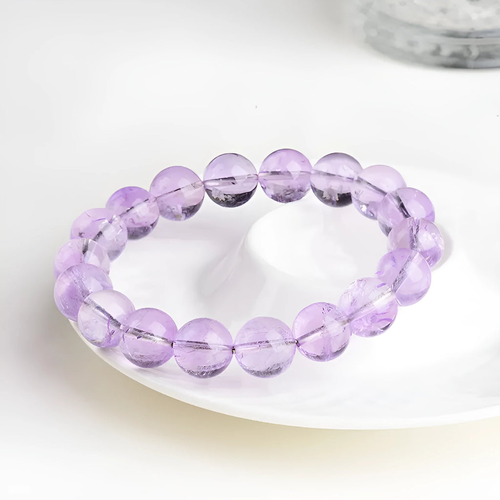 Lavender amethyst bracelet with round beads in a water ripple pattern, showing cream body and transparent colour options.