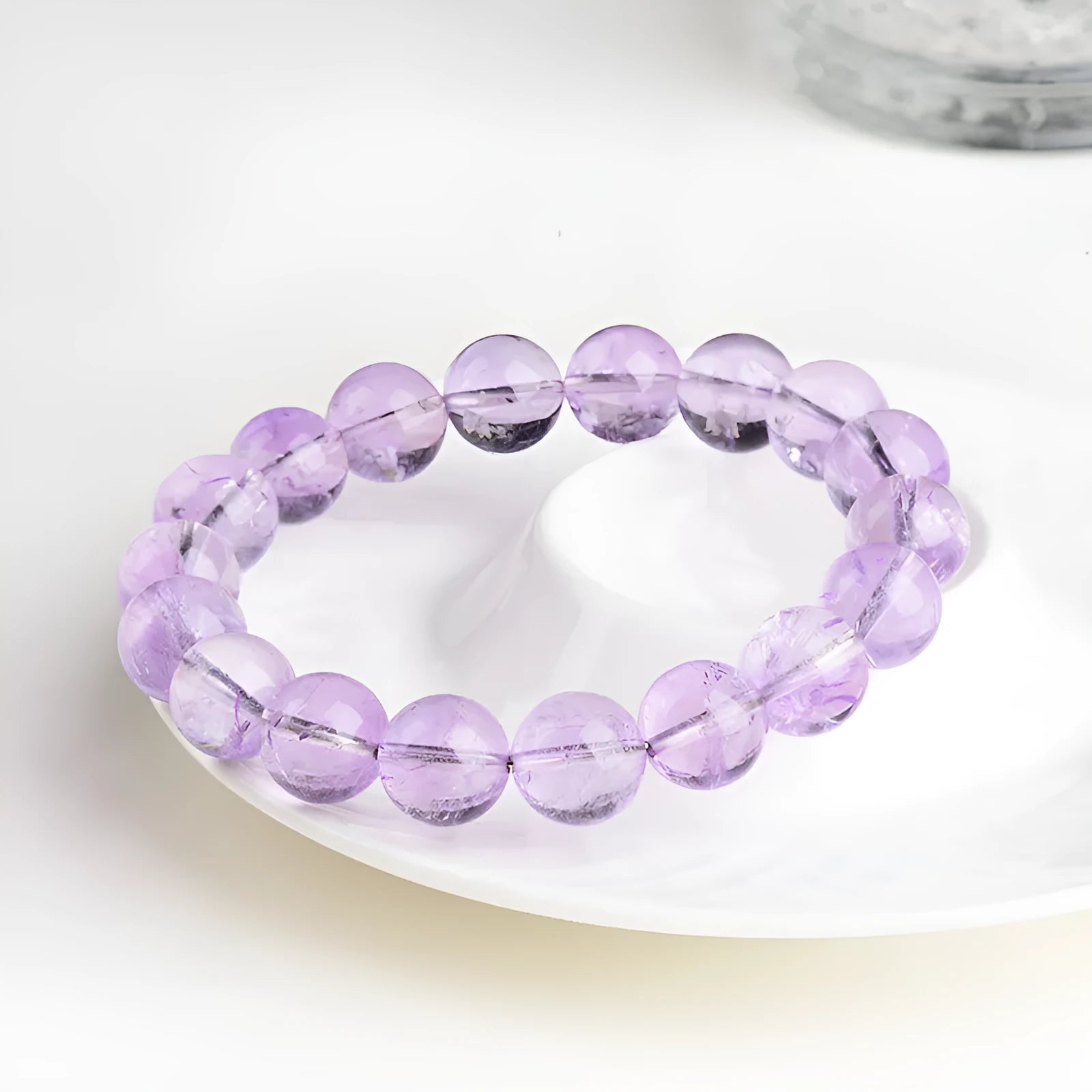 Lavender amethyst bracelet with round beads in a water ripple pattern, showing cream body and transparent colour options.