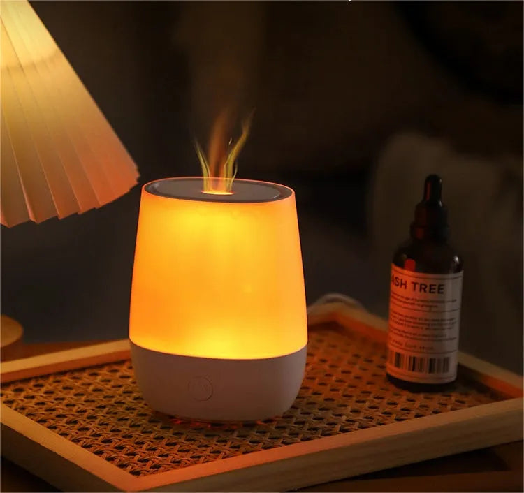 White USB aroma diffuser humidifier with flickering flame effect light on a wooden surface.