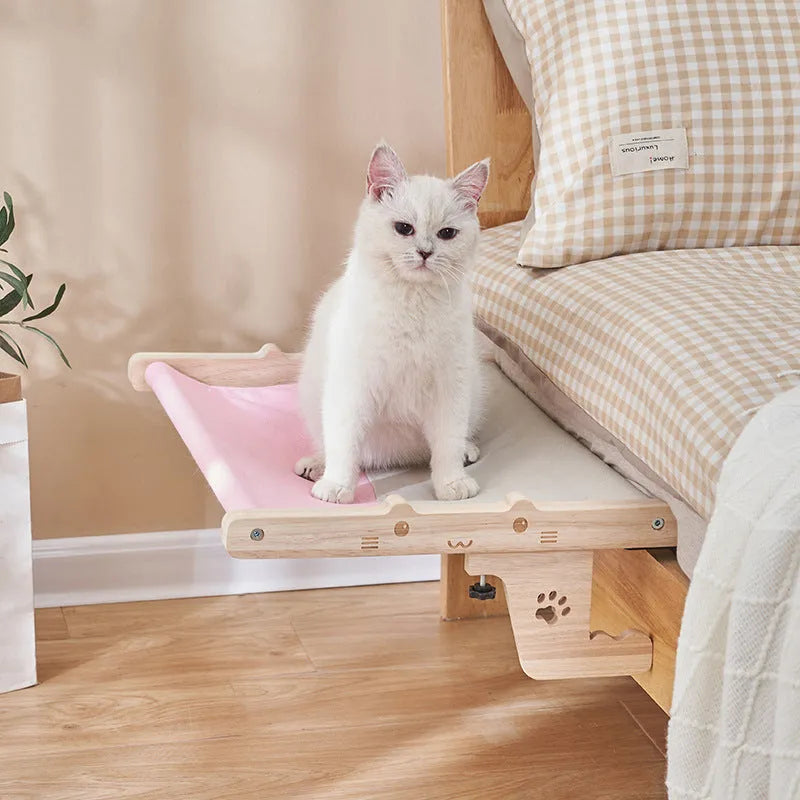 Wooden cat hanging bed hammock mounted on a balcony railing