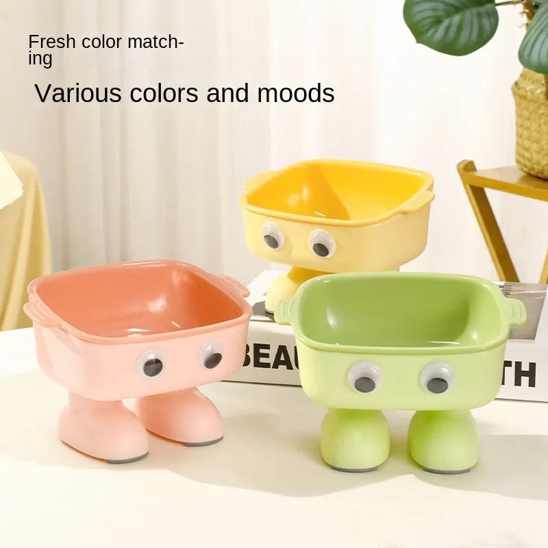 Green robot-shaped elevated cat bowl with tilted dish and non-slip base