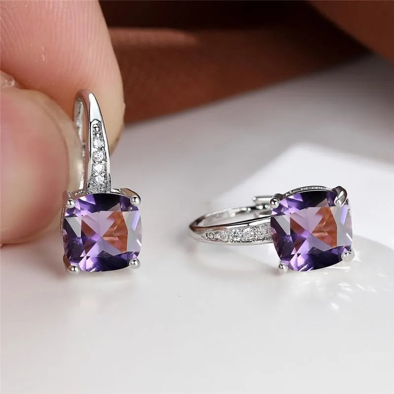 Square geometric ear hook earrings with zircon stones in an electroplated copper setting.