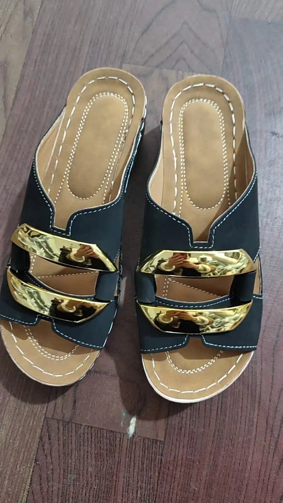 Roman-style platform flip-flops in a solid colour with a metal detail and rubber sole.