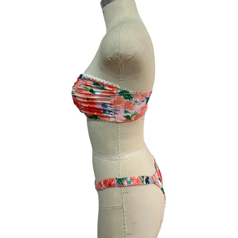 Blue floral print tube top bikini set with lace trim on a mannequin.