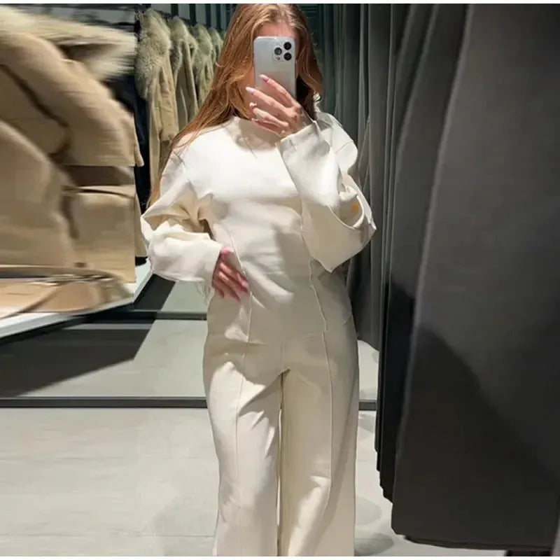 Women's apricot colour polar fleece lounge suit featuring a long sleeve pleated top and wide-leg trousers.