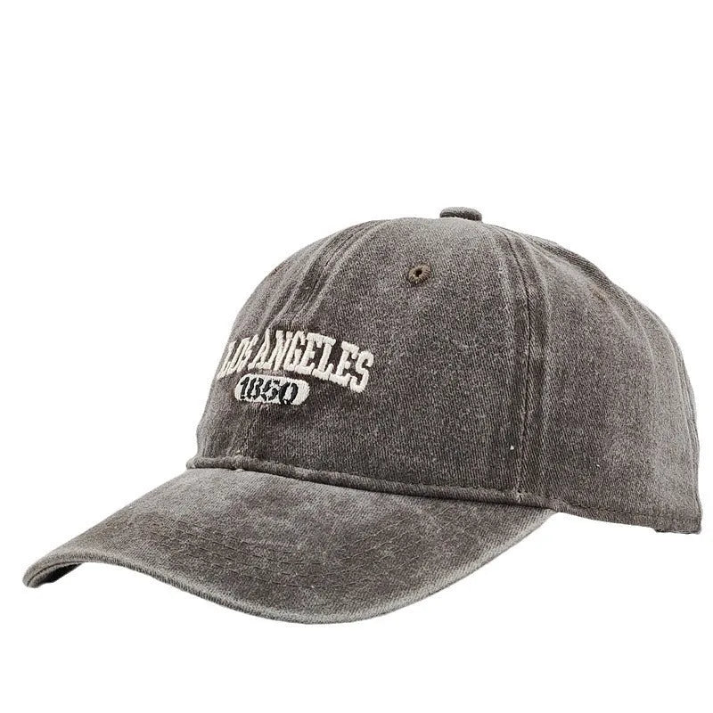 Retro peaked cap with distressed letter embroidery and adjustable sizing in conical crown design