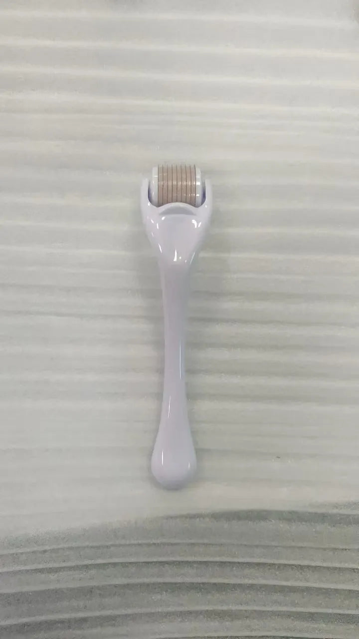 Black handle micro needle roller with purple wheel showing 540 stainless steel needles for dermaplaning