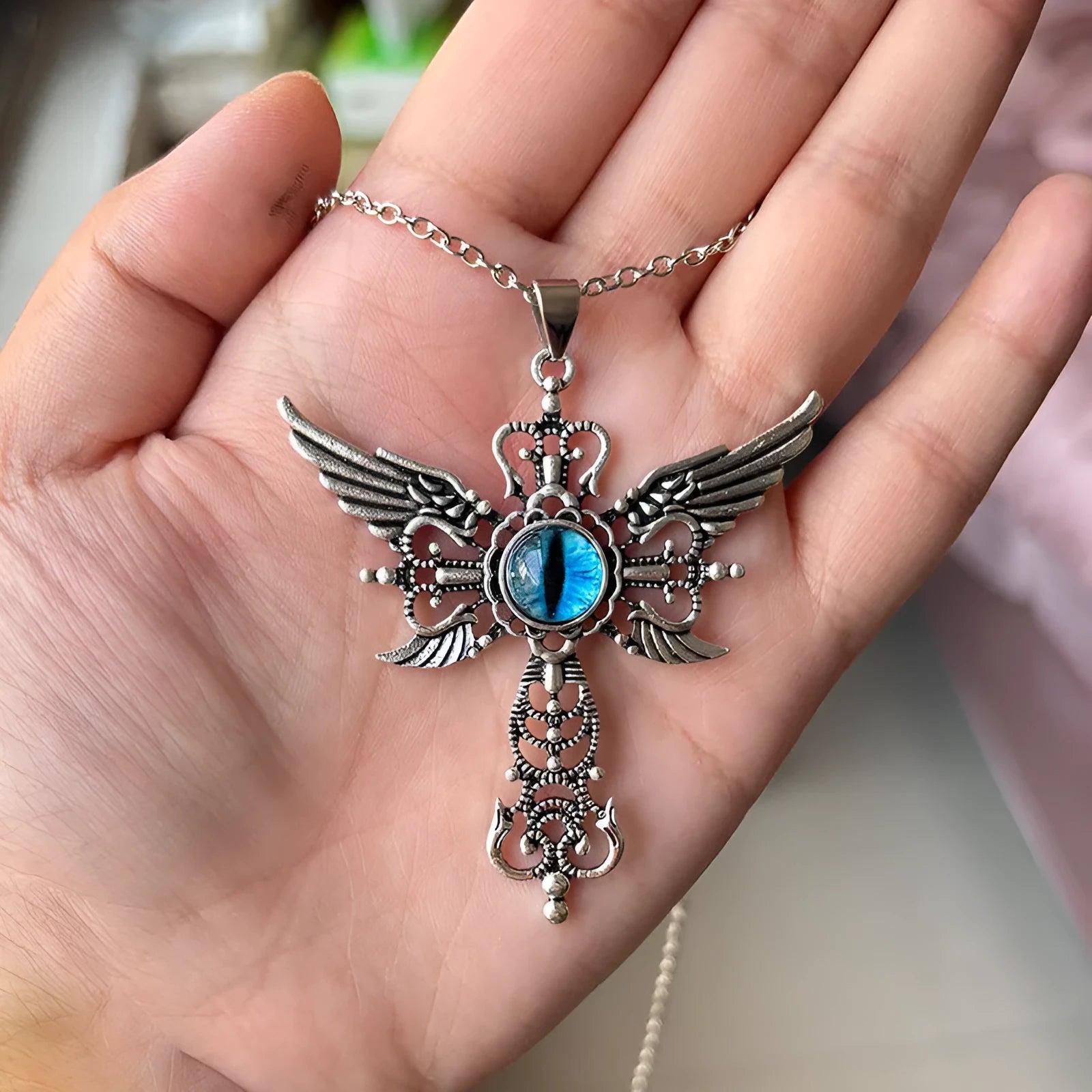Geometric devil wings and cross alloy pendant necklace on a chain, shown in blue, green, purple, red, and yellow colour options.