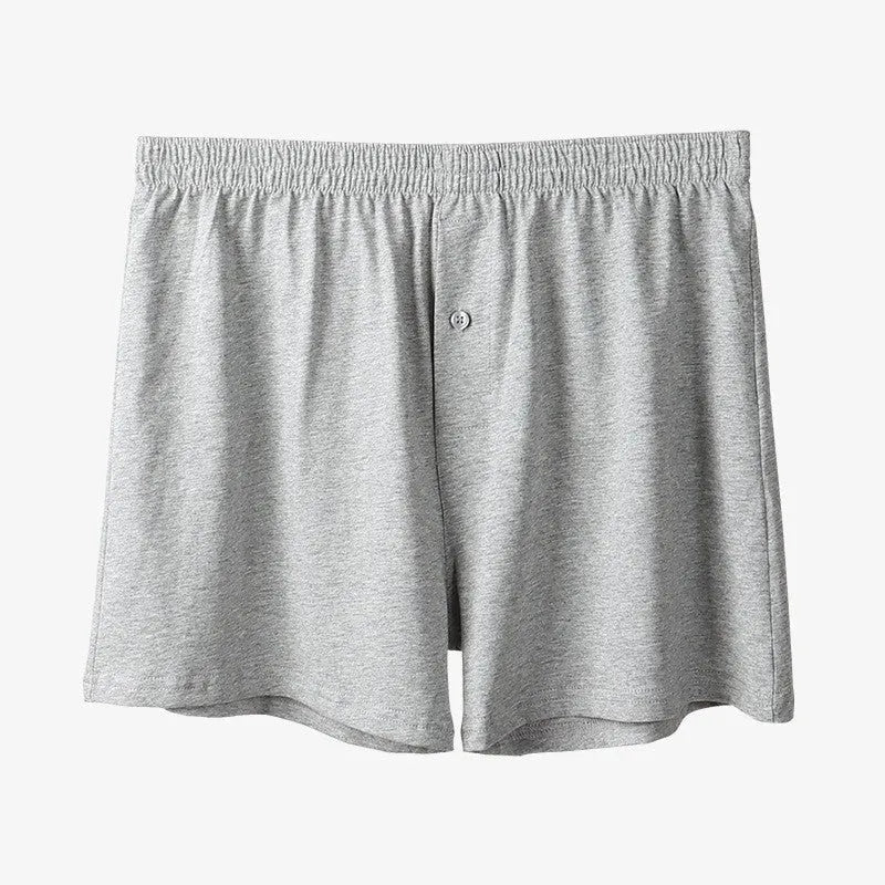 Men's solid-colour pure cotton boxer shorts with a high-waist and loose fit on a plain background.