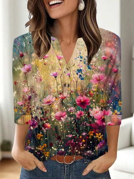 Woman wearing a loose V-neck T-shirt with a bold 3D pattern print in casual style.