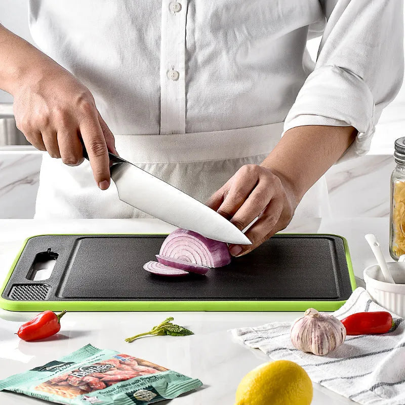 Square grey aluminium double-sided cutting board with defrosting function, built-in knife sharpener, and grinding teeth for garlic prep