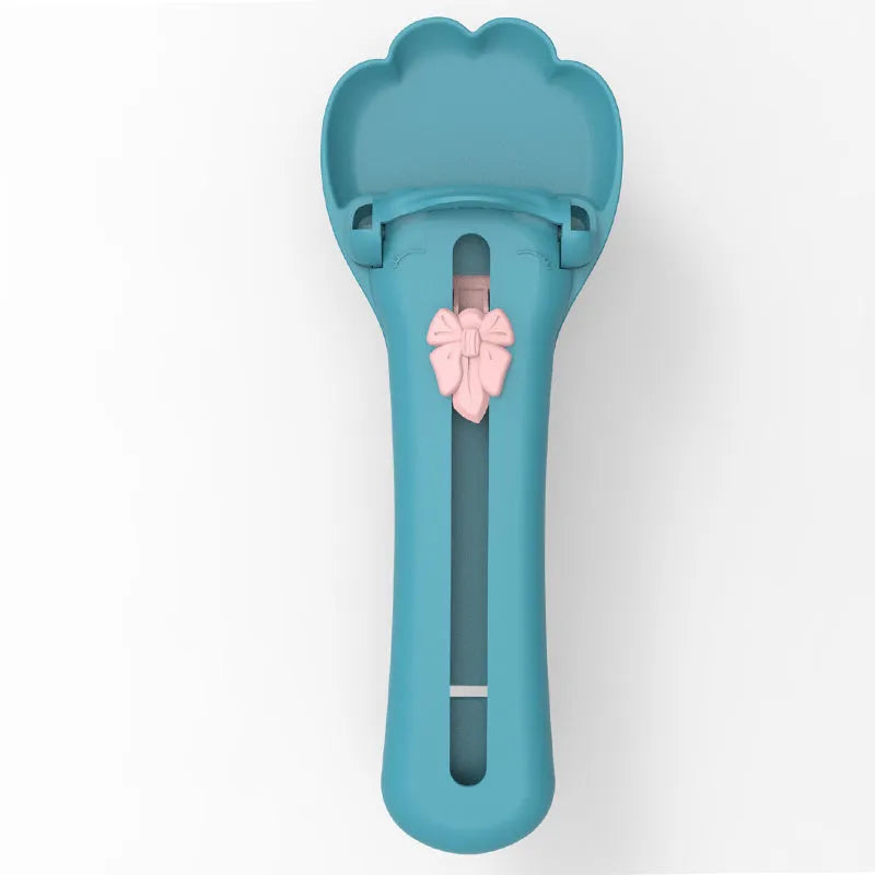 Green and pink pet feed spoon with silicone barrel for squeezing out sticky dog or cat food.