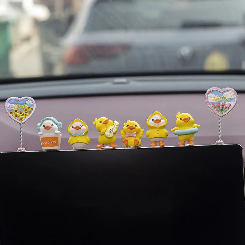 PVC cartoon duckling car decoration set with six small ducks and one Hello sign on a dashboard.