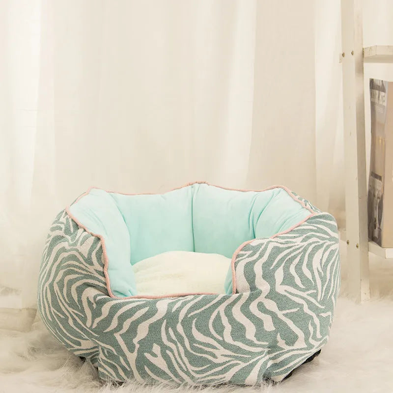 Blue octagonal pet sofa bed with a removable central mat for a small dog or cat.