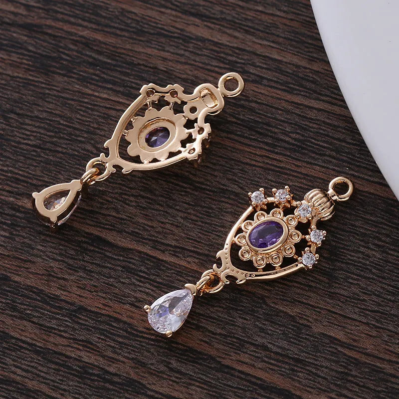 Hollow water drop shaped pendant with micro inlaid zircon on a crown outline in five colour options.