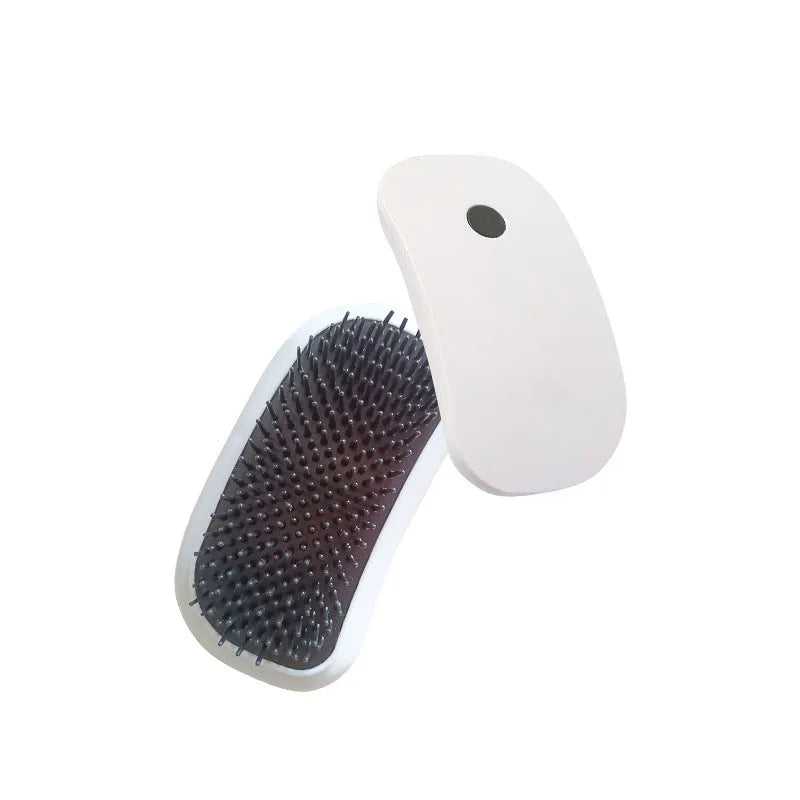 Pink handheld electric pet grooming massage brush with TPE teeth on a white background.