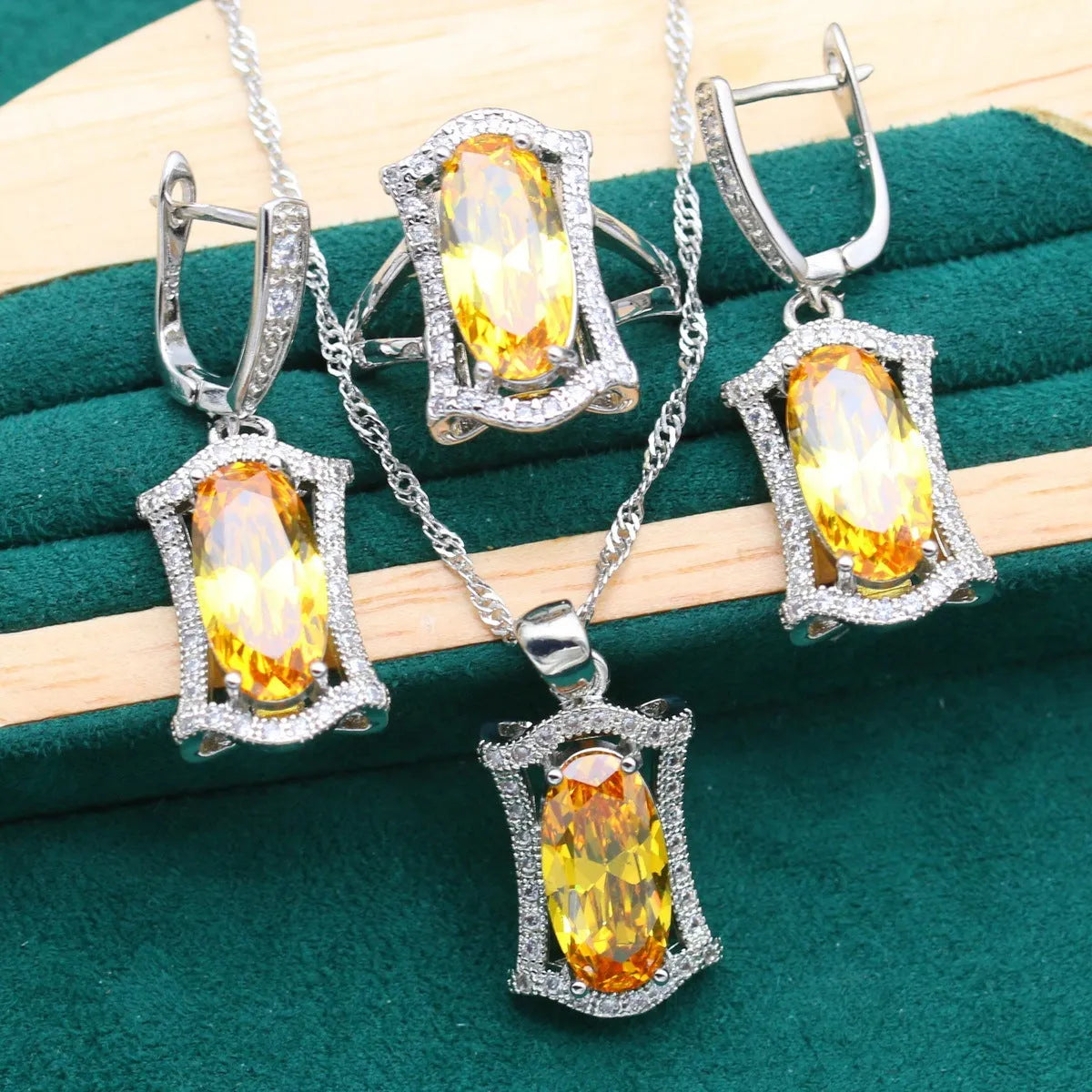Yellow zircon jewellery set showing necklace with snake bones chain, matching earrings, ring, and bracelet on a white background.
