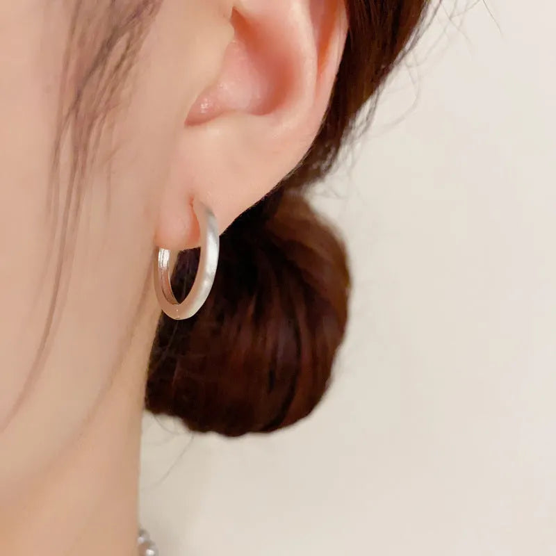 Geometric gold or silver-plated ear clip with round eyelet detail for women