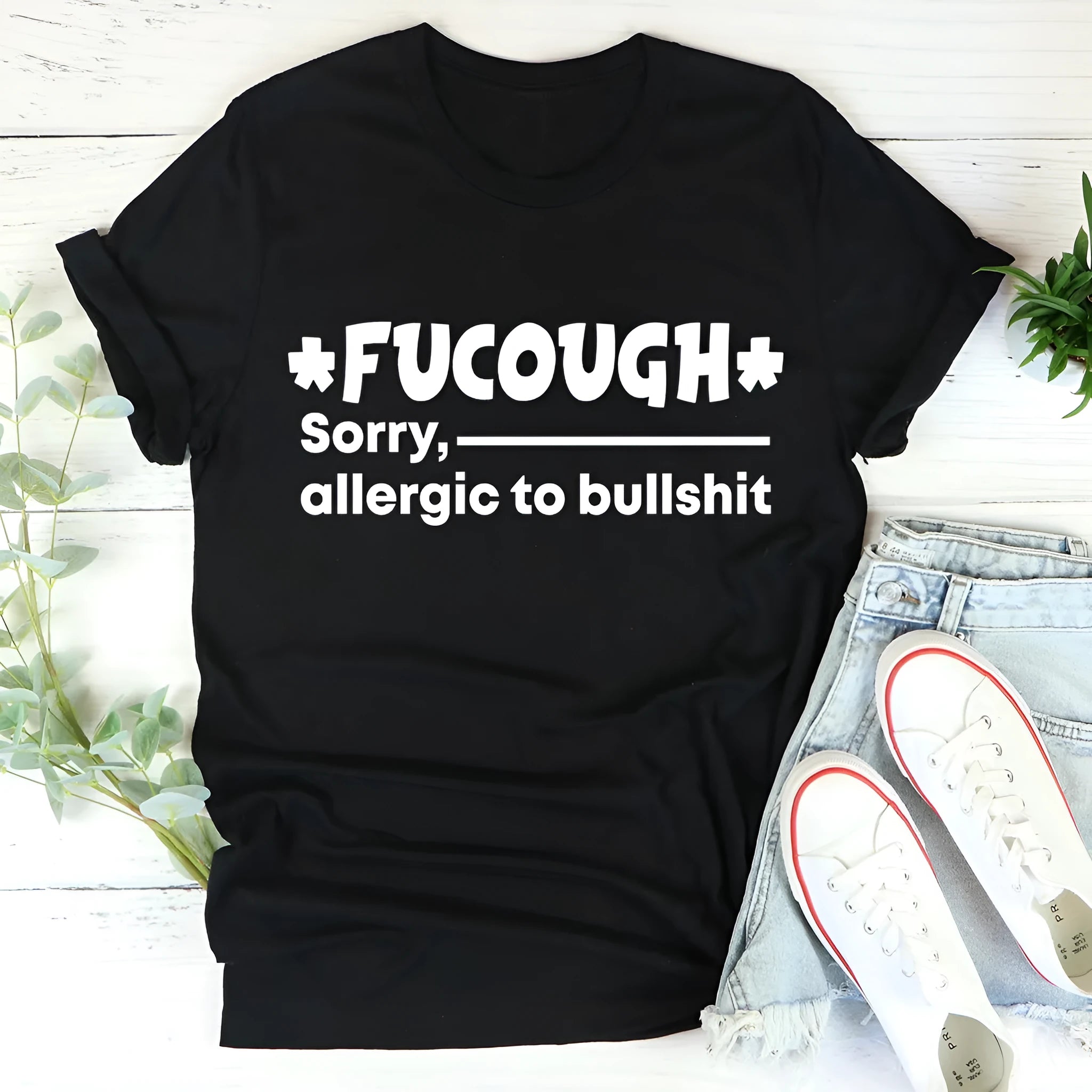 Black cotton loose fit t-shirt with short sleeves and a round neck on a hanger.