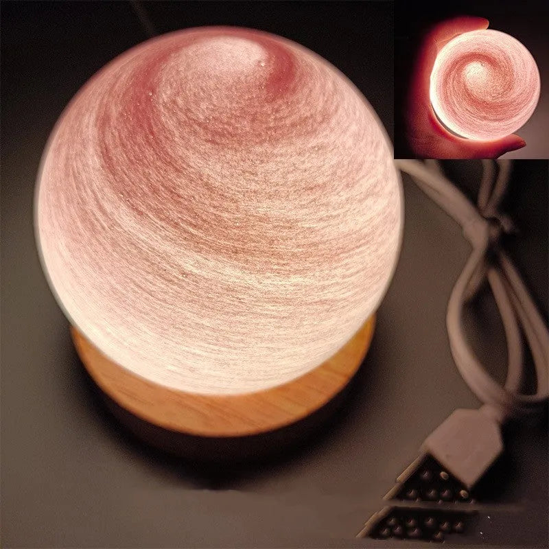 Compact modern planet USB night light on its base with dimmable three-colour lighting.
