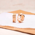Rose gold electroplated women's earrings with three hollow heart designs in circular frame