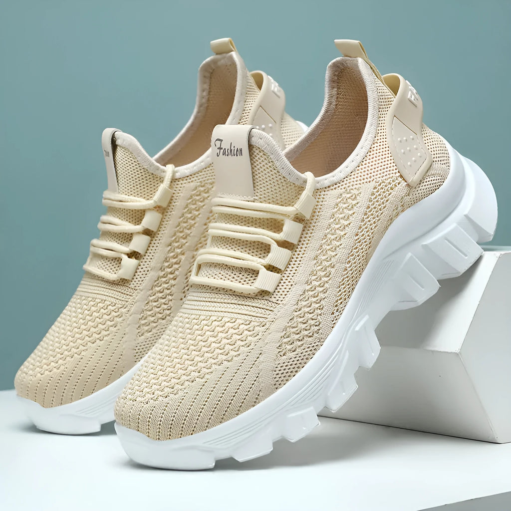 Women's white Flyknit sneaker with thick sole and lace-up front, shown on a neutral background