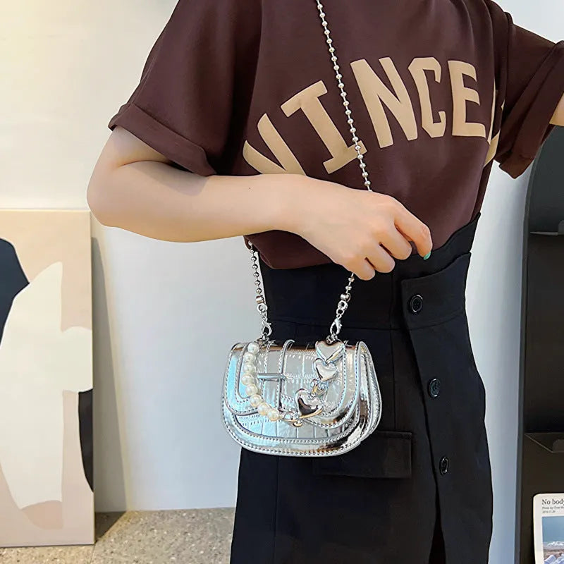 Laser pearl effect mini saddle tote handbag in horizontal square shape with crossbody strap