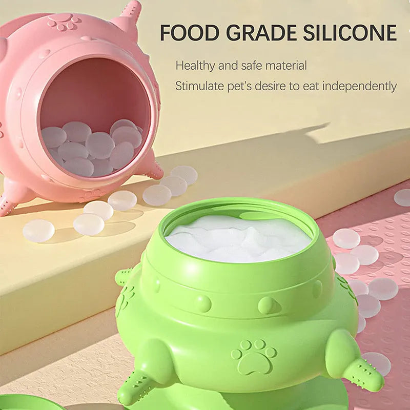 Pink silicone pet nursing milk bowl with four attached pacifiers on a flat base.