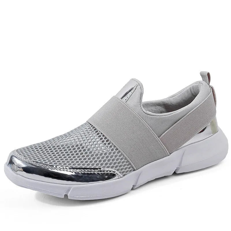 Blue, black, and grey women's low-cut mesh sneakers with a PU midsole on a hard floor.